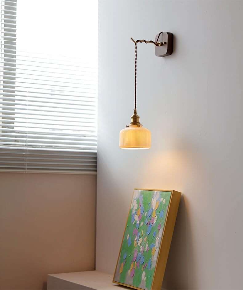 Japanese style ceramic wall lamp with copper arm and walnut canopy, featuring a modern design and white ceramic lampshade.