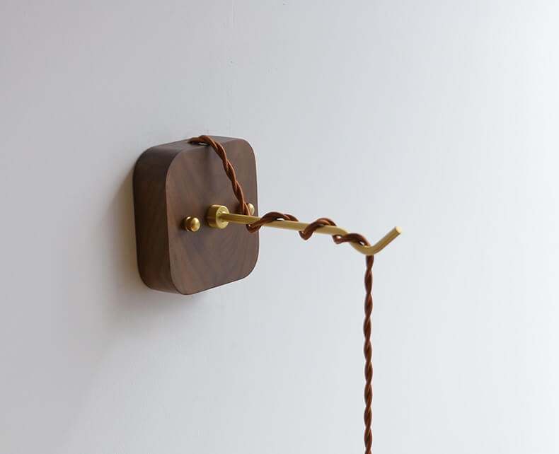 Japanese style ceramic wall lamp with copper arm and walnut canopy, featuring a modern design and white ceramic lampshade.
