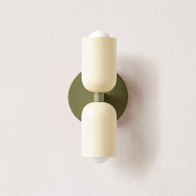 Modern cream metal wall scone with vary colors, sleek design for living or dining spaces.