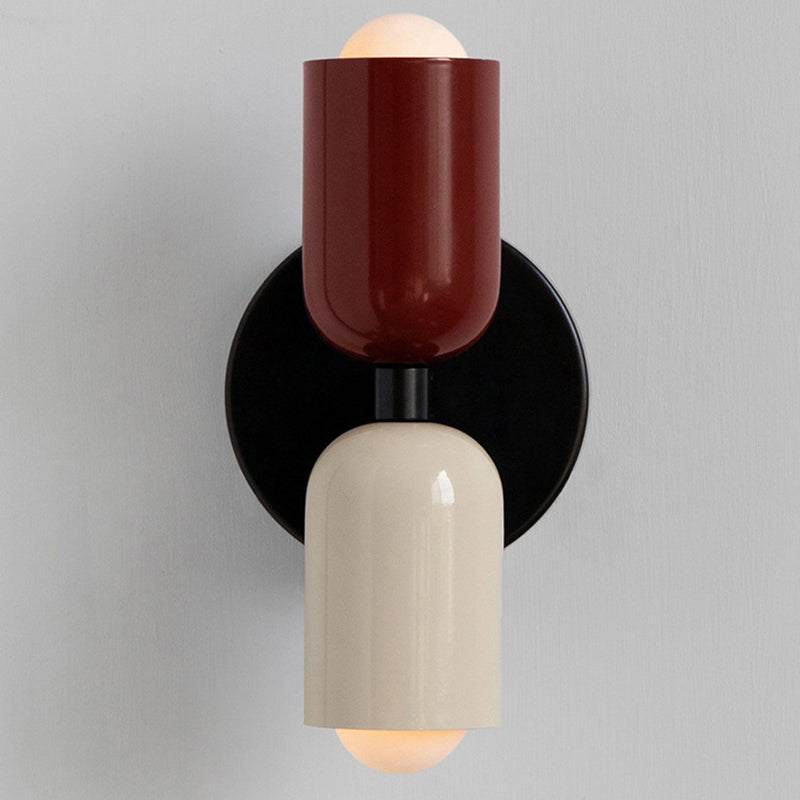 Modern cream metal wall scone with vary colors, sleek design for living or dining spaces.