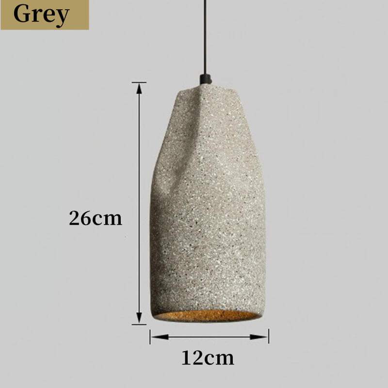 Industrial-style concrete pendant lights hanging over a kitchen island, showcasing minimalist design and modern elegance in a Nordic cement finish.