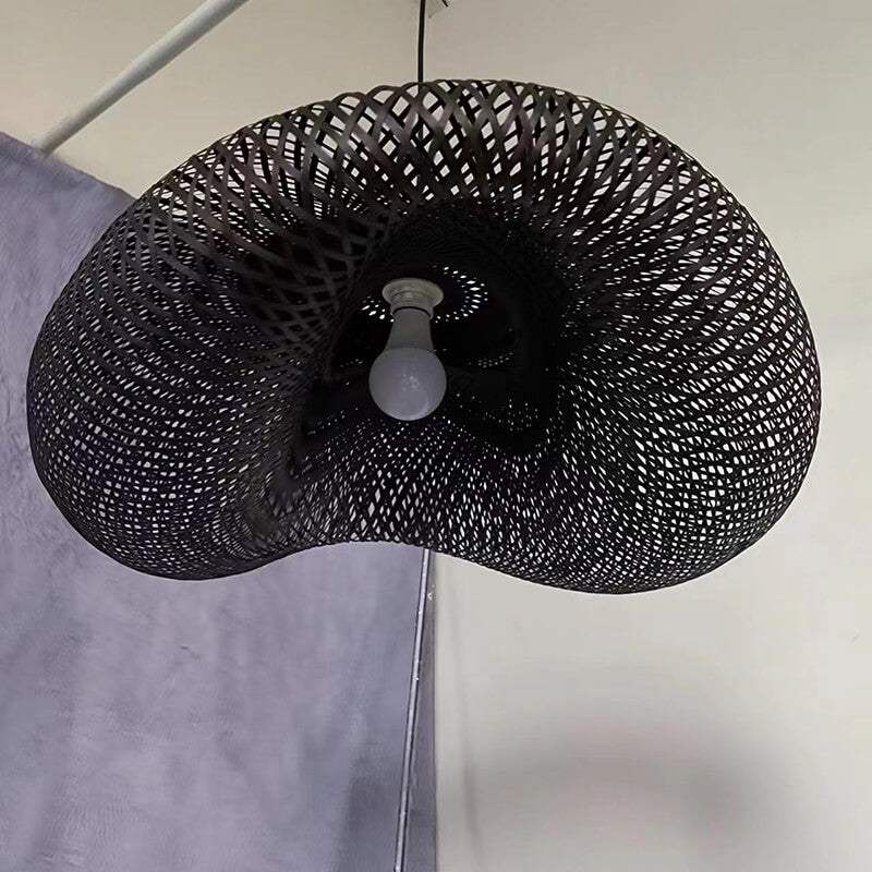 Black & beige bamboo weave pendant light fixture hanging from ceiling.
