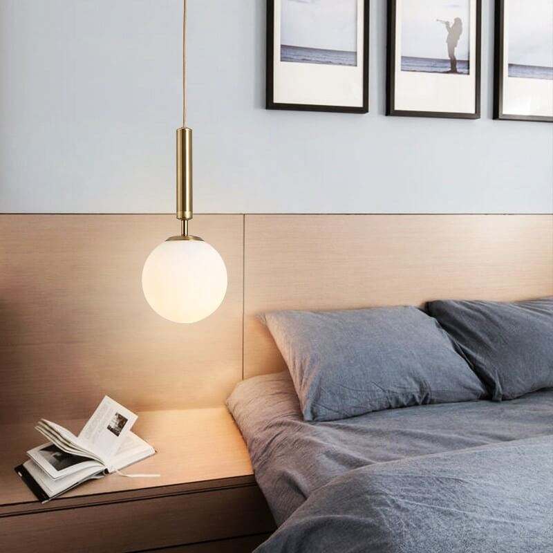 Modern Glass Ball Light Fixture hanging over a bedside table adding elegance to the bedroom decor.