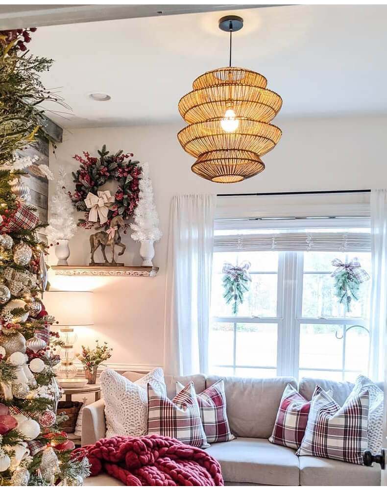 Boho rattan lamp hanging in a cozy bedroom with natural light.