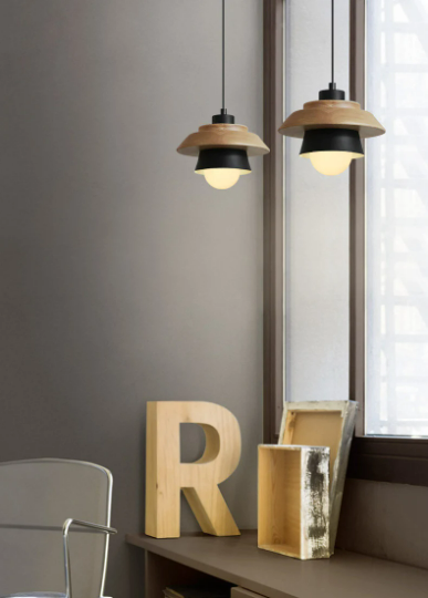 Nordic-style iron and wood sconce pendant light hanging in a rustic interior.
