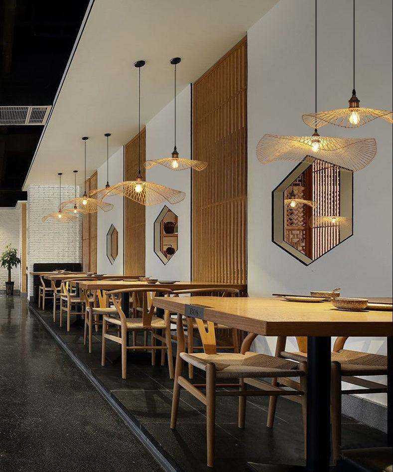 Handcrafted bamboo pendant lamp with butterfly design illuminating a modern interior space.