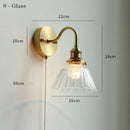 Clear glass wall lamp with pull chain switch, featuring a copper holder for durability and style.