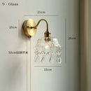 Clear glass wall lamp with pull chain switch, featuring a copper holder for durability and style.