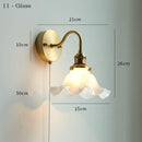 Glass wall lamp with pull chain switch, featuring a copper holder for durability and style.