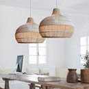 Japanese rattan lamps with white rattan lamp shades hanging over a dining table, showcasing hand-knitted craftsmanship and elegant design.