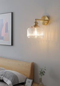 Clear Glass Wall Light LED with minimalist design, mounted above a bedside for cozy interior lighting.