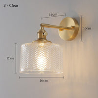 Clear Glass Wall Light LED with minimalist design, mounted above a bedside for cozy interior lighting.