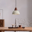 Handmade ceramic pendant light with wooden accents, featuring a minimalist design ideal for modern interiors.