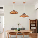 Retro straw hat wooden hanging lamps above dining table in cozy kitchen setting.