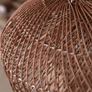 Vintage rattan hanging light with rustic look in a cozy dining space.