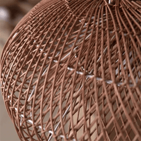 Vintage rattan hanging light with rustic look in a cozy dining space.