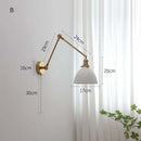 Modern ceramic wall lamp with copper swing arm and LED sconce, ideal for versatile home lighting.