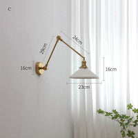 Modern ceramic wall lamp with copper swing arm and LED sconce, ideal for versatile home lighting.