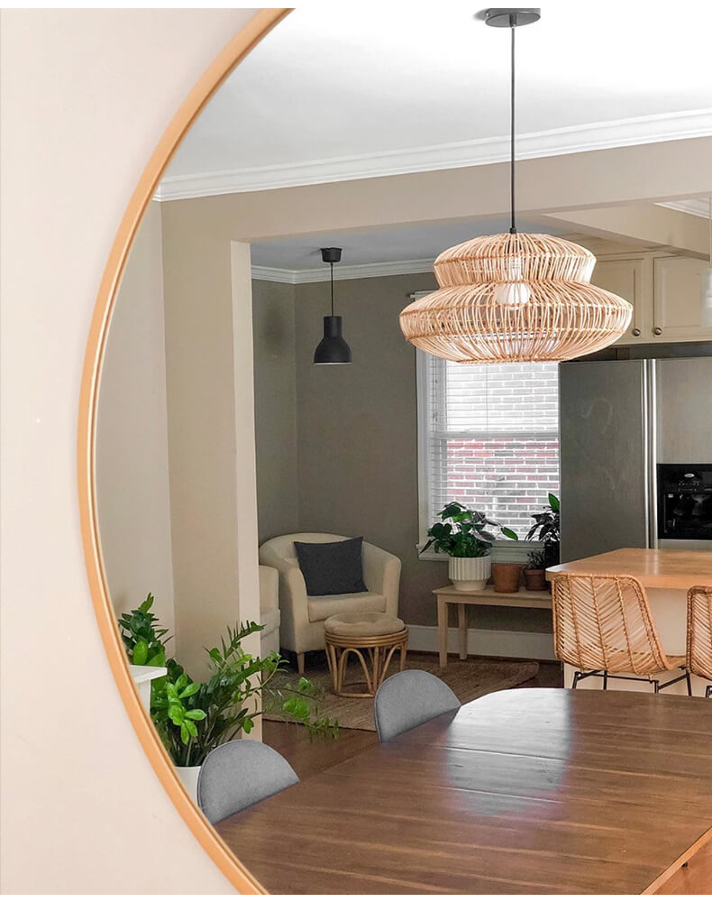 Boho rattan lamp hanging in a cozy bedroom with natural light.