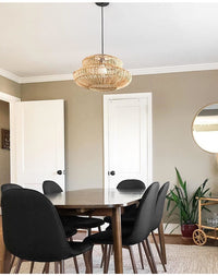 Boho rattan lamp hanging over kitchen island with elegant dining setup.