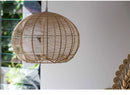 Wicker globe chandelier made of rattan, providing a rustic and elegant lighting solution.