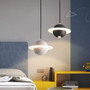 Modern LED cement pendant lamp in bedroom setting, featuring Nordic styling and adjustable cords for contemporary interiors.