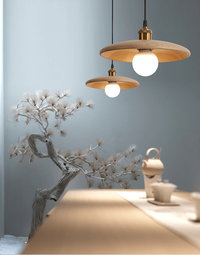 Nordic Flying Saucer Pendant Lights with wooden saucer shape, hanging in a modern room setting.