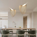 Nordic wood pendant light with snail-shaped design, LED lighting, in a modern living room setting.