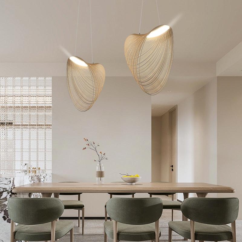 Nordic wood pendant light with snail-shaped design, LED lighting, in a modern living room setting.